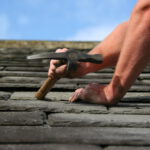 roofer fixing a tiled roof